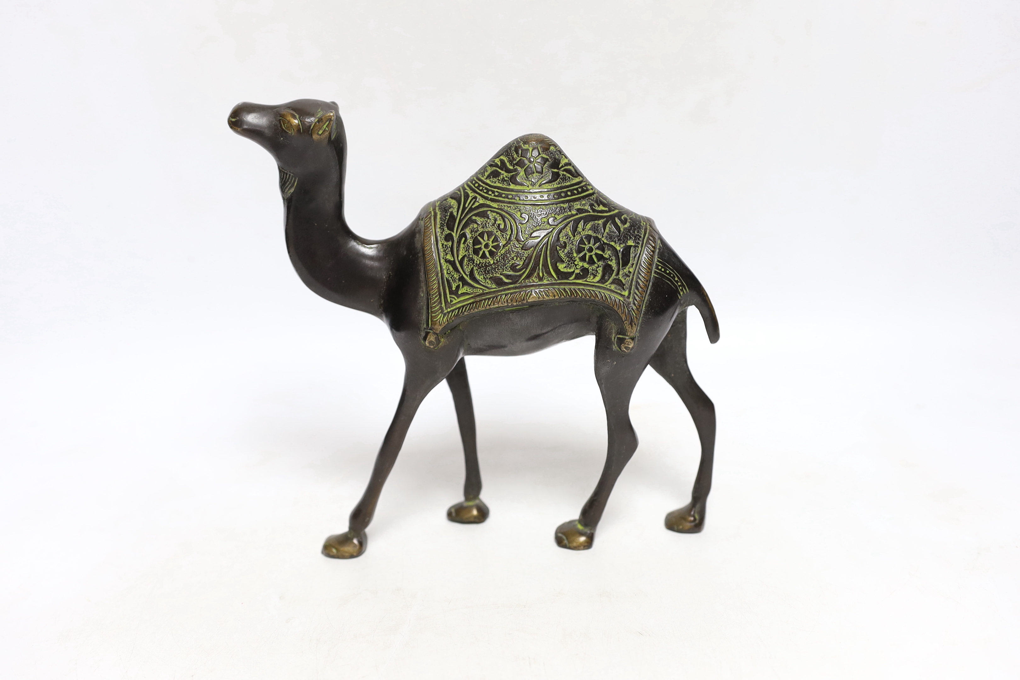 An Eastern bronze figure of a camel, 22cm wide
